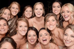 group of bridemaids smiling at the photo booth taking pictures